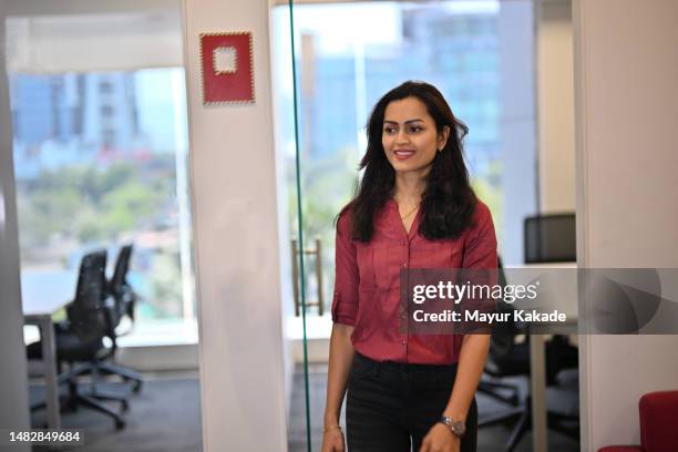 portrait of a mid adult woman in the office corridor - indian arrival stock pictures, royalty-free photos & images