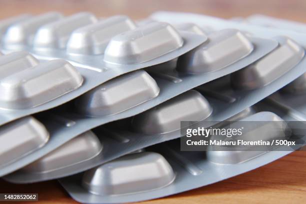 close up of pills of blister pack on table,romania - blister pack stock-fotos und bilder