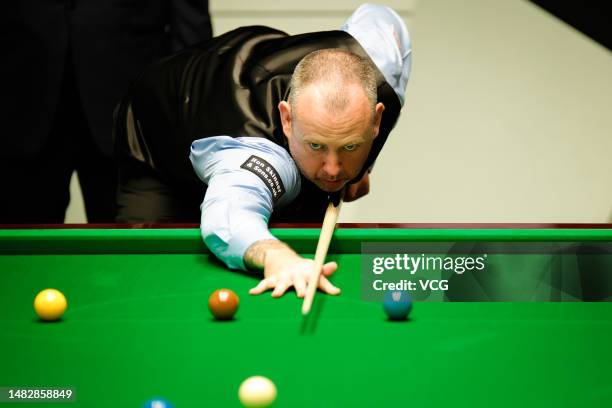 Mark Williams of Wales plays a shot in the first round match against Jimmy Robertson of England on day 3 of the 2023 Cazoo World Championship at...