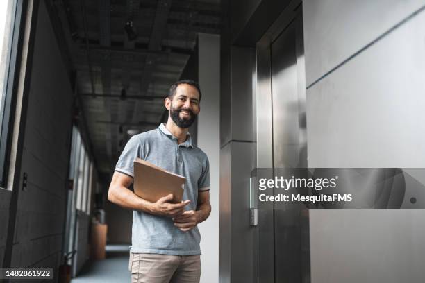 senior student in university hallway - teacher with folder stock pictures, royalty-free photos & images