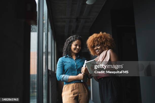 coworkers in the hallway of the company - collaborators stock pictures, royalty-free photos & images