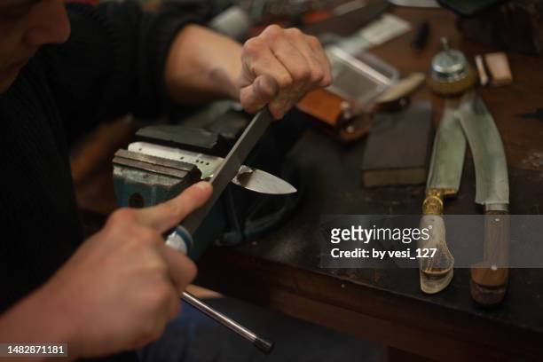 a knife master filing a blade - kitchen knife bildbanksfoton och bilder