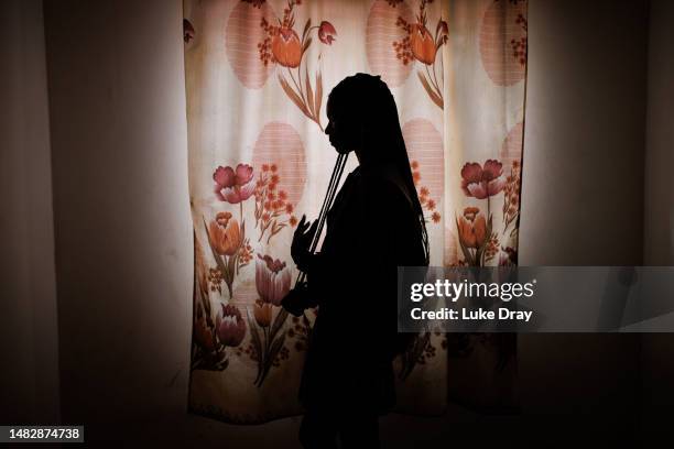 Transgender woman, going through transition, poses for a portrait at a safe house supporting LGBTQ residents on April 17, 2023 in Kampala, Uganda....