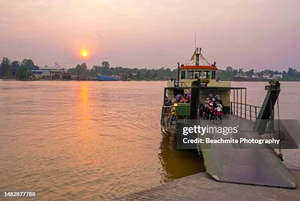 a ferry about to leave the  waterfront jetty at sunset - sibu river stock pictures, royalty-free photos & images
