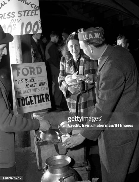 Two United Auto Workers get coffee and food during the Detroit Ford Motor Company strike near the Ford River Rouge complex in Dearborn, Michigan,...