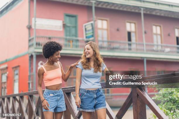women chatting while walking on the city street - lima peru stock pictures, royalty-free photos & images
