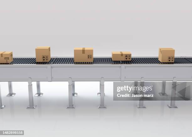 cartons on a conveyor belt on white - fließband stock-fotos und bilder