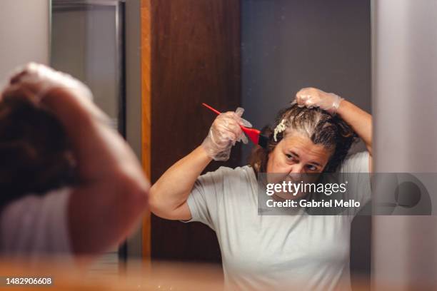 woman dyeing the hair at home - hair color stock pictures, royalty-free photos & images