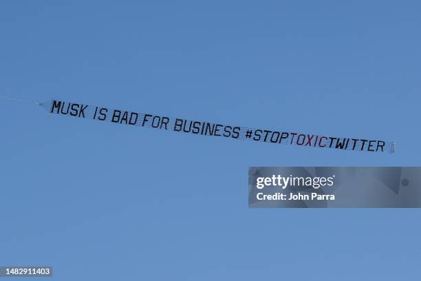 The #StopToxicTwitter coalition flies a banner urging brands not to advertise on Twitter over The Fontainebleau Hotel on April 17, 2023 in Miami...