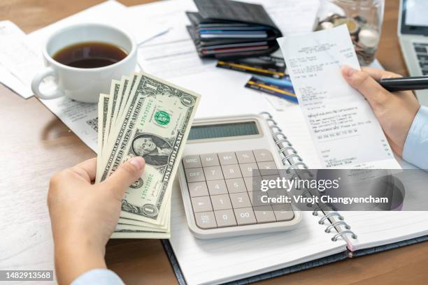 hands holding invoice and remaining money on hand, monthly budgeting concept. - add list stock pictures, royalty-free photos & images