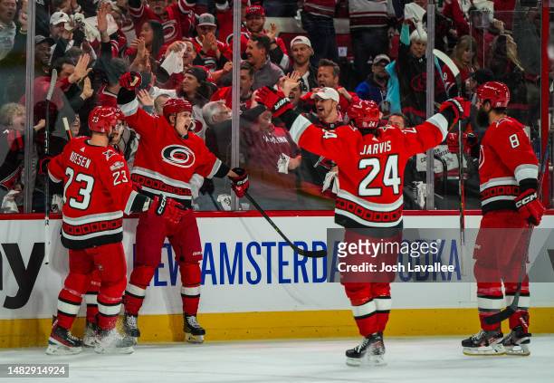 Sebastian Aho of the Carolina Hurricanes celebrates with teammates after scoring a goal during the first period against the New York Islanders in...