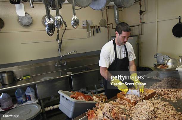 Steve Spoon chops pork after it was removed from a smoker at Bill Spoon's Barbecue on July 12, 2012 in Charlotte, North Carolina. The nearly...