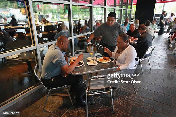 Diners eat lunch at The King's Kitchen on July 11, 2012 in Charlotte, North Carolina. The King's Kitchen is a not-for-profit restaurant located in...