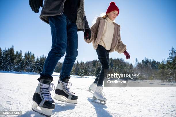 daughter ice skating with father on lake - ice skate bildbanksfoton och bilder