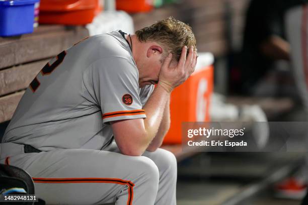 Logan Webb of the San Francisco Giants sits in the dugout after being pulled from the game in the seventh inning against the Miami Marlins at...