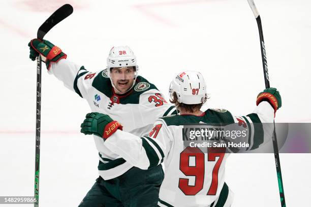 Kirill Kaprizov of the Minnesota Wild is congratulated by Mats Zuccarello after scoring a goal during the first period against the Dallas Stars in...