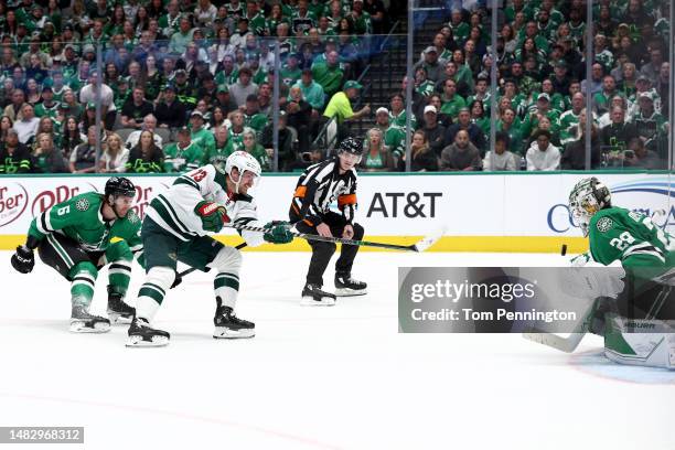 Sam Steel of the Minnesota Wild scores a goal against Jake Oettinger of the Dallas Stars and Colin Miller of the Dallas Stars in the second period in...