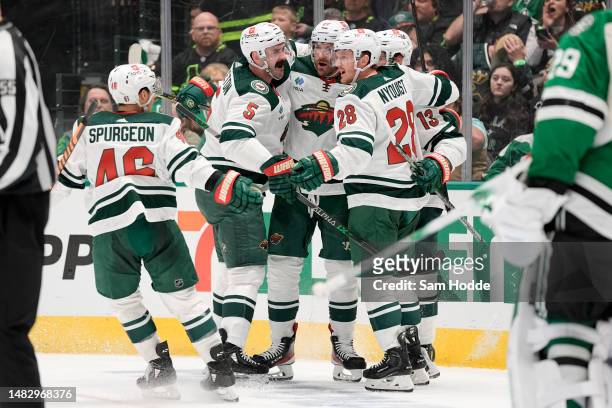 Sam Steel of the Minnesota Wild is congratulated by teammates after scoring a goal during the second period against the Dallas Stars in Game One of...