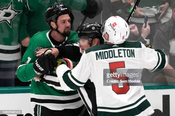 Jamie Benn of the Dallas Stars and Jake Middleton of the Minnesota Wild are separated by an official during the second period in Game One of the...