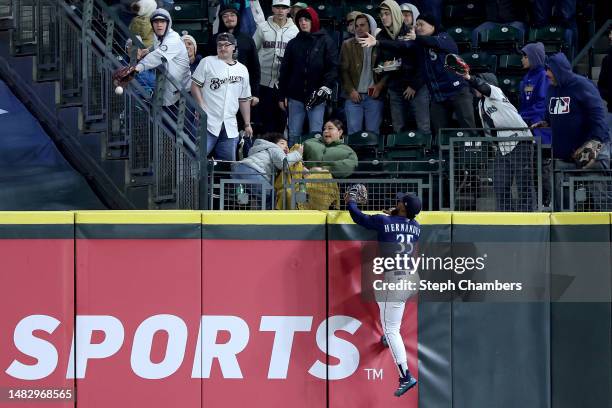 Teoscar Hernandez of the Seattle Mariners can't catch a home run by Brice Turang of the Milwaukee Brewers during the seventh inning at T-Mobile Park...