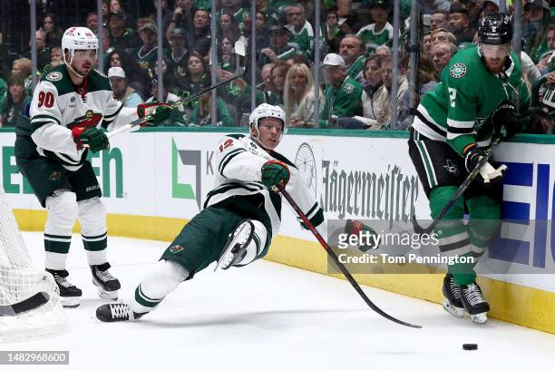 Jani Hakanpää of the Dallas Stars controls the puck against Matt Boldy of the Minnesota Wild in the second period in Game One of the First Round of...