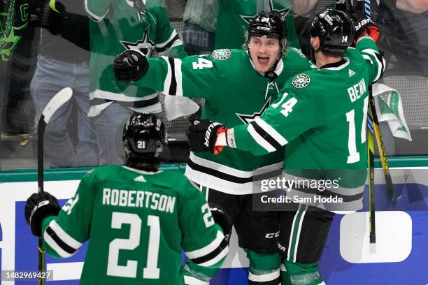 Roope Hintz of the Dallas Stars celebrates with Jamie Benn and Jason Robertson after scoring a goal during the second period against the Minnesota...