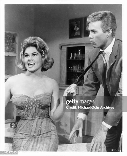 Sue Ane Langdon pulling on the tie of Harve Presnell in a scene from the film 'When The Boys Meet The Girls', 1965.