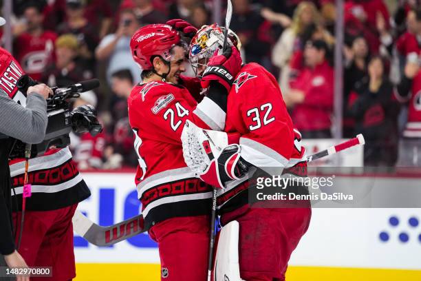 Seth Jarvis of the Carolina Hurricanes congratulates Antti Raanta after defeating the New York Islanders in Game One of the First Round of the 2023...