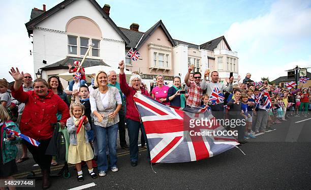 In this handout image provided by LOCOG, Crowds wait for the Olympic Flame to pass through Poole during Day 56 of the London 2012 Olympic Torch Relay...
