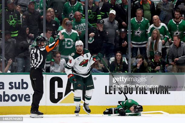 Joe Pavelski of the Dallas Stars lays on the ice after a hit from Matt Dumba of the Minnesota Wild in the second period in Game One of the First...