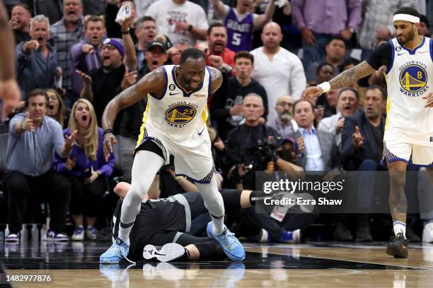 Draymond Green of the Golden State Warriors steps over Domantas Sabonis of the Sacramento Kings in the second half during Game Two of the Western...