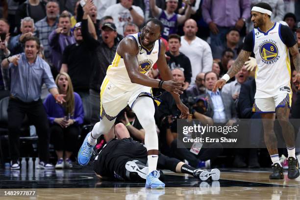 Draymond Green of the Golden State Warriors steps over Domantas Sabonis of the Sacramento Kings in the second half during Game Two of the Western...