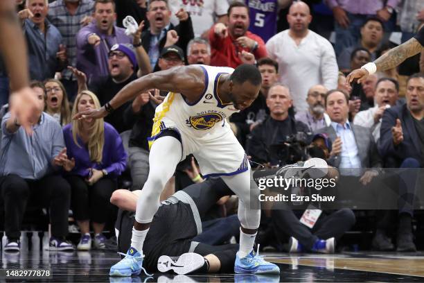 Draymond Green of the Golden State Warriors steps over Domantas Sabonis of the Sacramento Kings in the second half during Game Two of the Western...