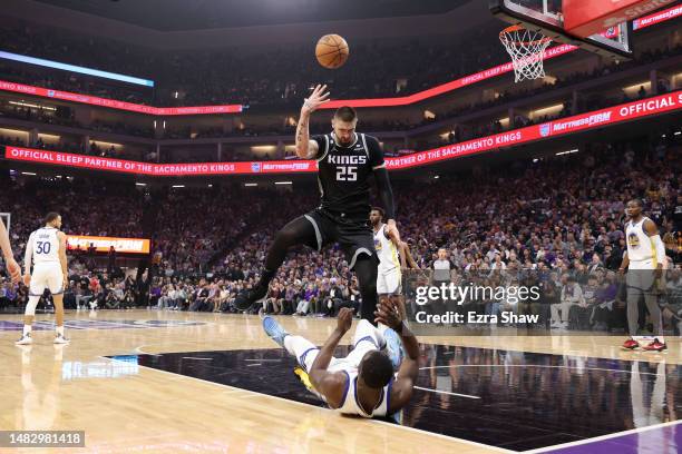 Draymond Green of the Golden State Warriors draws an offensive foul on Alex Len of the Sacramento Kings in the first half during Game Two of the...