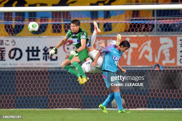 Takayuki Nakahara of Vegalta Sendai competes for the ball against Akihiro Hayashi and Yeo Sung-hae of Sagan Tosu during the J.League J1 match between...