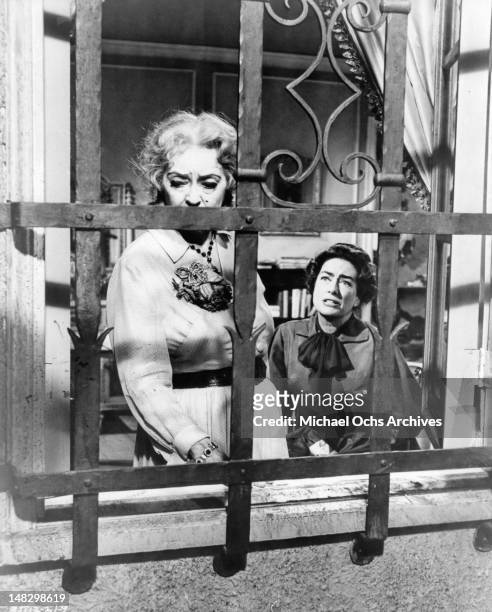 Bette Davis looking out the window as Joan Crawford pleads with her in a scene from the film 'What Ever Happened To Baby Jane?', 1962.