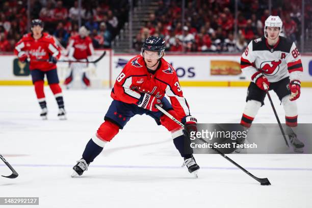 Rasmus Sandin of the Washington Capitals skates with the puck against the New Jersey Devils during the second period of the game at Capital One Arena...