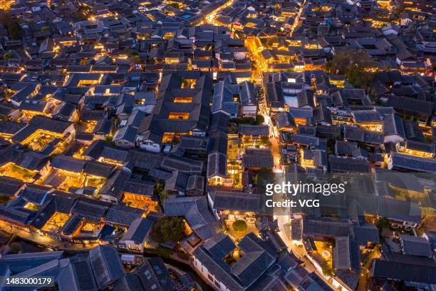 Aerial view of illuminated Lijiang Old Town at night on April 16, 2023 in Lijiang, Yunnan Province of China.