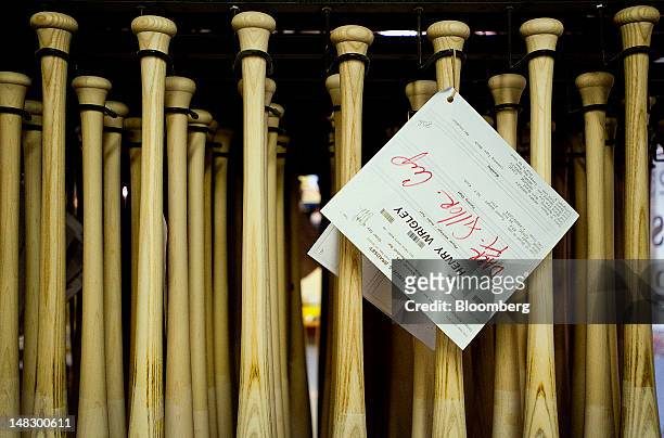 Custom made bats for Major League Baseball players dry on the galzing rack at the Louisville Slugger Museum and Factory in Louisville, Kentucky,...