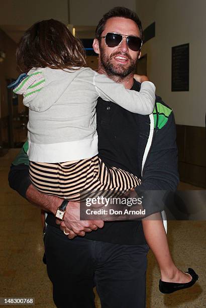 Hugh Jackman carries his daughter Ava as he arrives at Sydney International Airport on July 14, 2012 in Sydney, Australia.