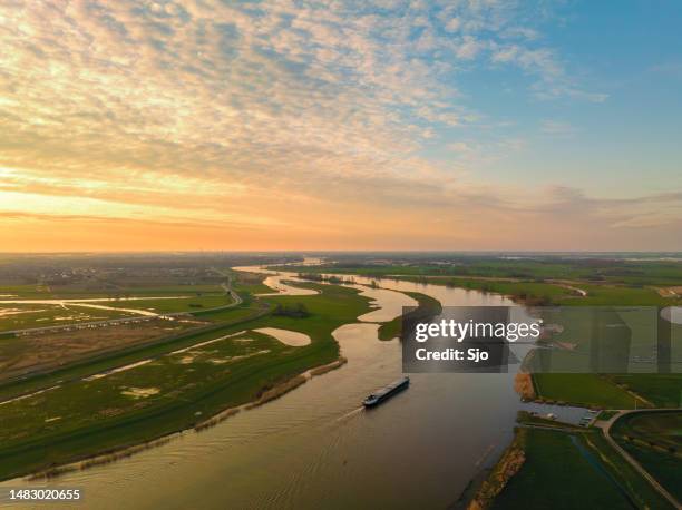 ship sailing on the river ijssel during sunset panoramic bird's eye view - kampen overijssel stock pictures, royalty-free photos & images