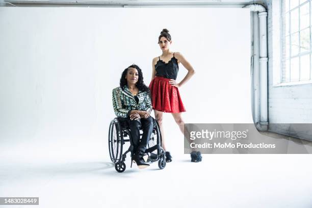 portrait of female fashion designer in wheelchair with female model - sia - fotografias e filmes do acervo