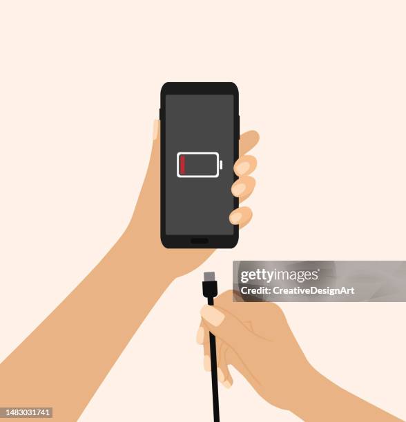 hand holding a mobile phone and charger. low battery symbol on phone screen - loading vector stock illustrations