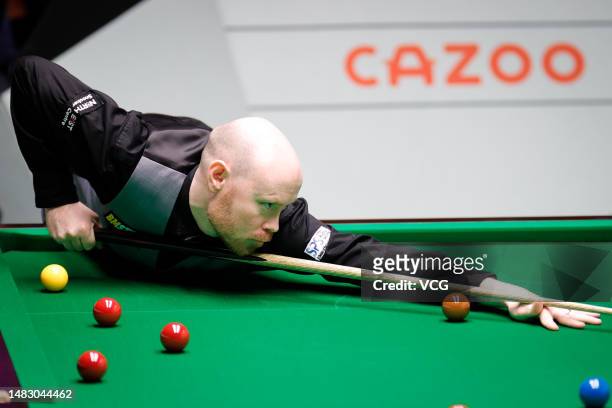 Gary Wilson of England plays a shot in the first round match against Elliot Slessor of England on day 4 of the 2023 Cazoo World Championship at...
