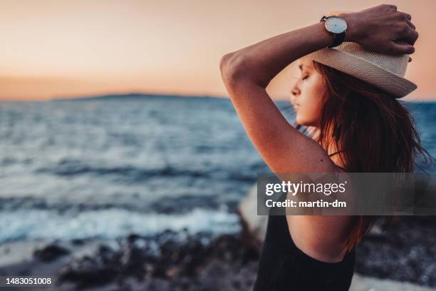 woman at the seaside enjoying the sunset - bulgaria beach stock pictures, royalty-free photos & images