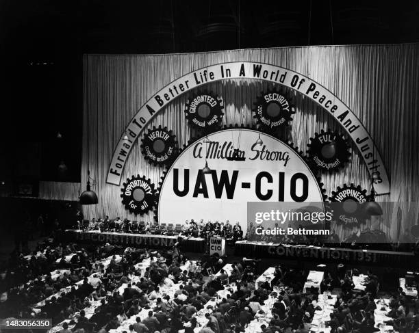 General view of delegates at the 1951 United Automobile Workers convention in Cleveland, Ohio, April. The banner reads 'Forward to a Better Life in a...