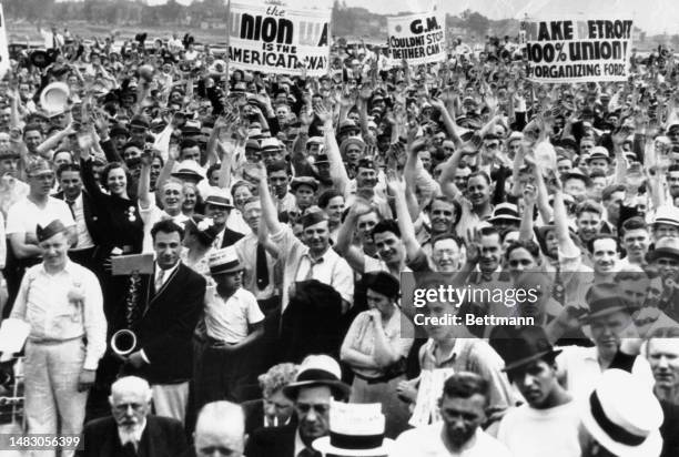 Supporters of the United Auto Workers of America union cheering speakers at a demonstration in River Rouge, Michigan, on June 6th, 1937. The protest...