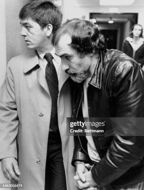 Murder suspect John Stanfa is escorted by an FBI agent as he is brought before a federal magistrate in Hyattsville, Maryland, on December 16th, 1980....