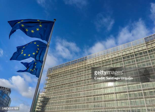 european union flags waving at berlaymont building of the european commission - quartier européen bruxelles photos et images de collection