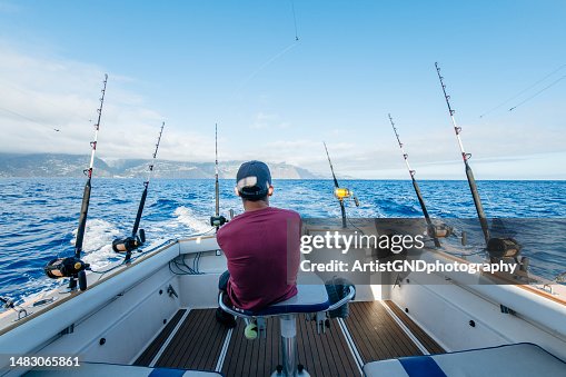 Man on a boat fishing for tuna fish in the ocean. Man on a boat fishing for tuna fish in the ocean.